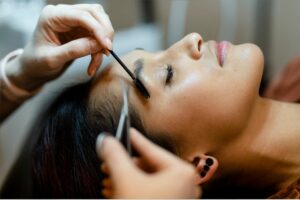 customer-getting-eyebrow-treatment-at-a-beauty-salon