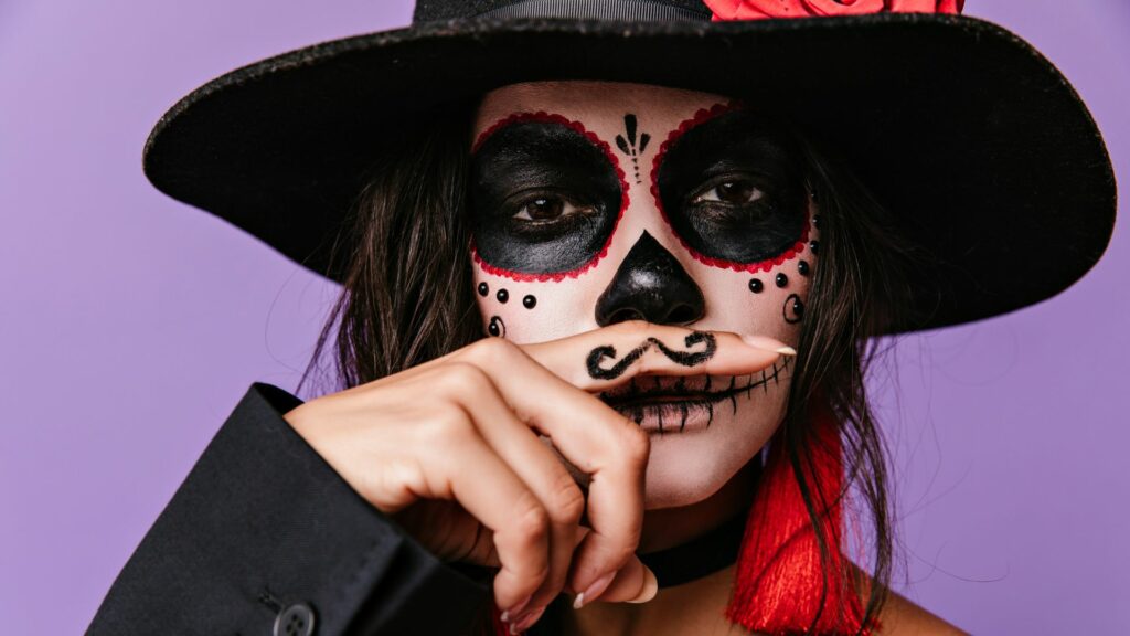 A woman wearing skin-friendly face paint and a moustache, ideal for achieving flawless Halloween makeup.
