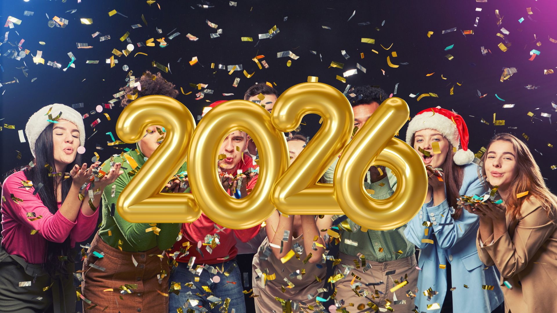 A group of people in festive attire and hats are blowing confetti, celebrating the New Year with large gold 2026 balloons in the foreground, capturing a sense of personal growth.