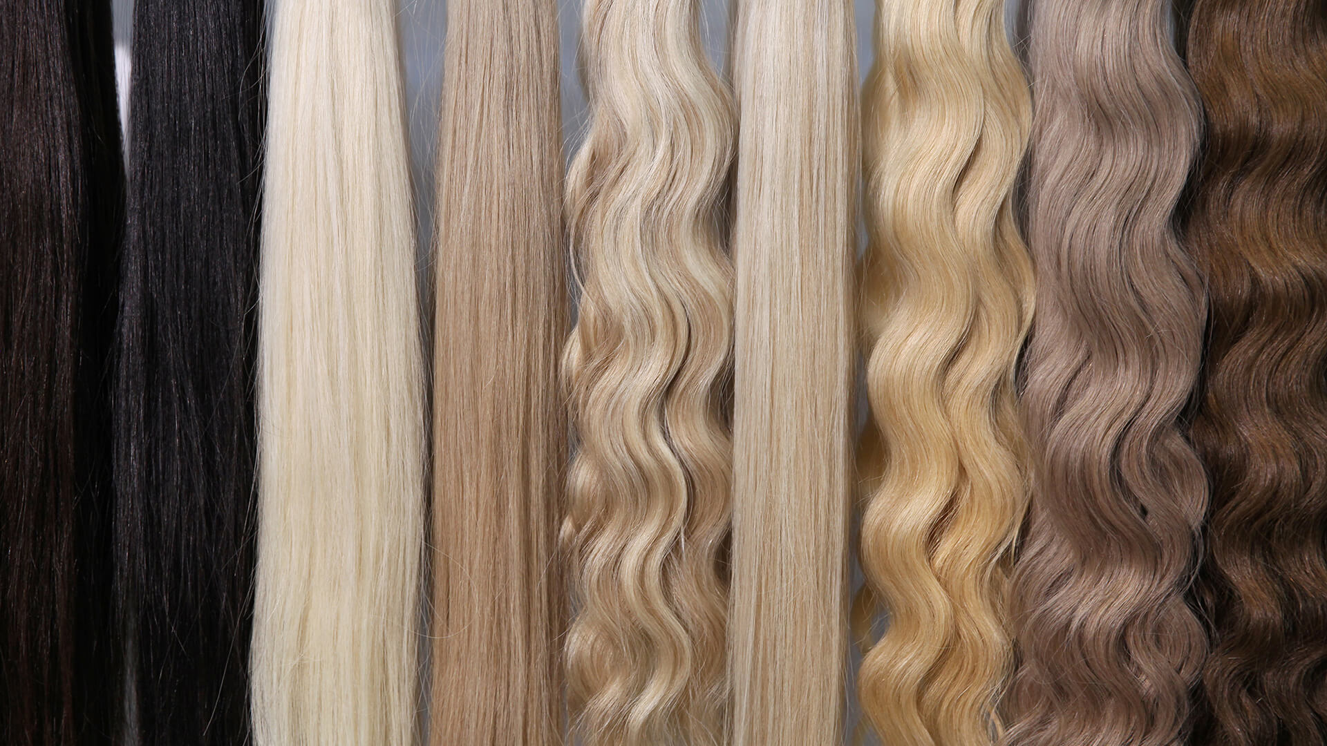 Eight 2026 hair extensions, ranging from black to light blonde, shown vertically. Some are straight and others have loose waves—ideal for adding volume and highlighting various textures and shades.